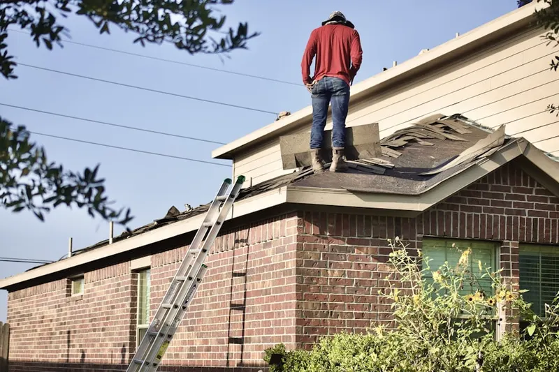 Professional roofer working on a residential roof in Aldie